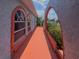 Showcasing the unique architectural design featuring arched windows and a vibrant walkway at 2432 Caretta Ave, Spring Hill, FL 34609