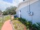 Side exterior view of home with fence, green lawn and bushes at 2432 Caretta Ave, Spring Hill, FL 34609