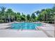 Large community pool surrounded by lush landscaping and lounge chairs at 2723 Garden Falls Dr, Brandon, FL 33511