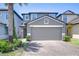 Charming two-story home with a two-car garage, a brick driveway, and lush landscaping at 2723 Garden Falls Dr, Brandon, FL 33511