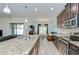 Modern kitchen featuring granite countertops and stainless steel appliances overlooking the dining area at 2723 Garden Falls Dr, Brandon, FL 33511