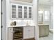 Charming bar area with wine fridge, glass-front cabinets, and convenient access to a half bath at 3109 W Granada St, Tampa, FL 33629