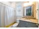 Bathroom featuring a shower-tub combo, granite vanity, and a large mirror at 3109 W Granada St, Tampa, FL 33629