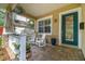 Inviting front porch with rocking chairs and a beautifully painted front door at 3109 W Granada St, Tampa, FL 33629