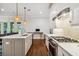 Bright, open kitchen with center island, stainless appliances, and hardwood flooring at 3109 W Granada St, Tampa, FL 33629