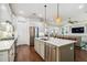 Well-designed kitchen featuring a gray island, stainless steel appliances, and hardwood floors at 3109 W Granada St, Tampa, FL 33629