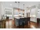 Spacious kitchen boasts gray island, modern lighting, stainless appliances, and hardwood floors at 3109 W Granada St, Tampa, FL 33629