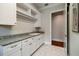 Spacious laundry room features a sink, granite counters, white cabinetry, and tiled floors at 3109 W Granada St, Tampa, FL 33629