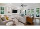 Spacious living room features hardwood floors, built-in shelving, and doors to the exterior at 3109 W Granada St, Tampa, FL 33629
