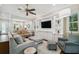 Open concept living room with hardwood floors, built-in shelving, and TV at 3109 W Granada St, Tampa, FL 33629