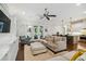 Bright living room featuring hardwood floors, neutral furniture, and seamless access to the modern kitchen at 3109 W Granada St, Tampa, FL 33629