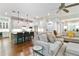 Open-concept living area with modern lighting, hardwood floors, and comfortable seating for entertaining at 3109 W Granada St, Tampa, FL 33629