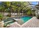 This is a beautiful pool with a screened enclosure and tropical plants at 3109 W Granada St, Tampa, FL 33629