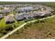 Aerial view of homes surrounding pond in quiet community at 3161 Satilla Loop, Odessa, FL 33556