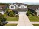 Aerial view of a well-maintained home with lush landscaping and a spacious driveway at 3161 Satilla Loop, Odessa, FL 33556