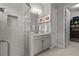 Bright bathroom features a glass shower, granite countertops, and access to a walk-in closet at 3161 Satilla Loop, Odessa, FL 33556