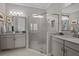 Bathroom featuring double sinks with granite countertops and a glass shower with tile surround at 3161 Satilla Loop, Odessa, FL 33556