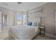 Serene bedroom with a white bed, neutral tones, and a large window with scenic views at 3161 Satilla Loop, Odessa, FL 33556