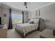 Comfortable bedroom with a queen-sized bed, neutral decor, and a window offering natural light at 3161 Satilla Loop, Odessa, FL 33556