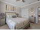 Comfortable bedroom features neutral color scheme, a ceiling fan and a large window at 3161 Satilla Loop, Odessa, FL 33556