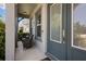 Inviting front porch with comfortable seating and a stylish blue front door at 3161 Satilla Loop, Odessa, FL 33556
