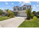 Well-maintained home with lush landscaping, a spacious driveway, and charming curb appeal at 3161 Satilla Loop, Odessa, FL 33556