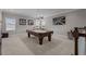 Spacious game room with a pool table, modern lighting, and decorative wall art at 3161 Satilla Loop, Odessa, FL 33556