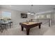 Spacious game room with a pool table, bar stools, and ample lighting, ideal for entertaining guests and Gathering fun at 3161 Satilla Loop, Odessa, FL 33556