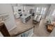 Open concept kitchen and dining area boasts stylish island, stainless appliances and modern finishes at 3161 Satilla Loop, Odessa, FL 33556