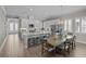 Spacious kitchen and dining area featuring stainless steel appliances, granite countertops, and a stylish pendant light at 3161 Satilla Loop, Odessa, FL 33556
