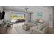 Bright and airy living room with sliding glass doors leading to the pool area, featuring comfortable seating and stylish decor at 3161 Satilla Loop, Odessa, FL 33556