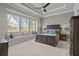 Serene main bedroom featuring a tray ceiling, large windows with natural light, and comfortable furnishings for relaxation at 3161 Satilla Loop, Odessa, FL 33556