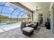 Lanai featuring sectional outdoor seating and an inviting pool with a screened enclosure at 3161 Satilla Loop, Odessa, FL 33556