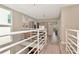Bright second floor hallway with modern railing leads to a home office and bedroom at 3412 W San Juan St # B, Tampa, FL 33629