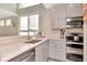 Modern kitchen with stainless steel appliances, light gray cabinets and white counters at 3412 W San Juan St # B, Tampa, FL 33629