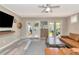 Bright living room featuring a ceiling fan, french doors, and hardwood floors at 3412 W San Juan St # B, Tampa, FL 33629