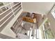 Open concept living room with hardwood floors, a leather couch, and a modern staircase at 3412 W San Juan St # B, Tampa, FL 33629