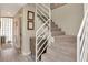 Carpeted staircase featuring modern white railing and light wood flooring at 3412 W San Juan St # B, Tampa, FL 33629