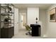 A modern home office featuring a black desk and a bookshelf storage unit at 36068 Risa Michele St, Zephyrhills, FL 33541