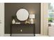 Elegant entryway with decorative mirror, table, lamp, and stylish decor at 36075 Risa Michele St, Zephyrhills, FL 33541