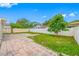 Fenced backyard featuring a small tree and a section of paved stones for outdoor enjoyment at 3927 Spence Ave, Tampa, FL 33614