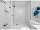 Contemporary bathroom featuring elegant marble tile in the shower, complemented by modern black fixtures and glass doors at 3927 Spence Ave, Tampa, FL 33614