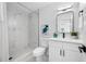 Modern bathroom showcasing marble tile in the shower, sleek fixtures, and a decorative vase adding a touch of elegance at 3927 Spence Ave, Tampa, FL 33614