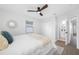 Cozy bedroom with a ceiling fan, closet, window with blinds, and access to an ensuite bathroom for convenience at 3927 Spence Ave, Tampa, FL 33614