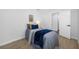 Comfortable bedroom with a bed, side table, and doorway at 3927 Spence Ave, Tampa, FL 33614