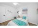 Bright bedroom with luxury vinyl plank flooring and a window with blinds at 3927 Spence Ave, Tampa, FL 33614