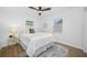 Bright bedroom with a ceiling fan, area rug, side table with decorative lamp, and natural light from the window at 3927 Spence Ave, Tampa, FL 33614