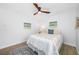 Well-lit bedroom featuring calming wall art, a ceiling fan, area rug, and neutral decor for a comfortable space at 3927 Spence Ave, Tampa, FL 33614