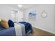Bright bedroom with luxury vinyl plank flooring, ceiling fan, and a neutral color palette at 3927 Spence Ave, Tampa, FL 33614