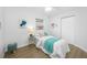 Bedroom featuring luxury vinyl plank flooring, a ceiling fan, and an accent table at 3927 Spence Ave, Tampa, FL 33614